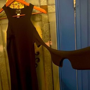 Black sexy mini dress fitted with holes throughout sleeves very unique.